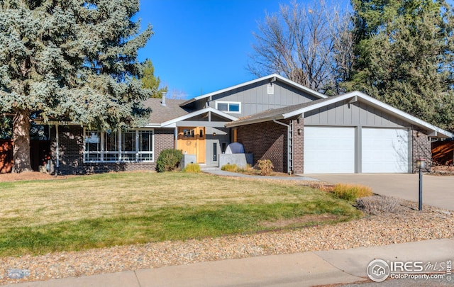 view of front of house with a front yard and a garage