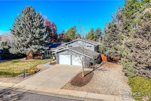 view of front of house featuring a garage and a front yard