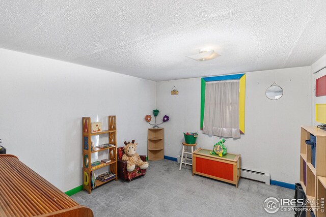 miscellaneous room with a textured ceiling, baseboard heating, and light carpet