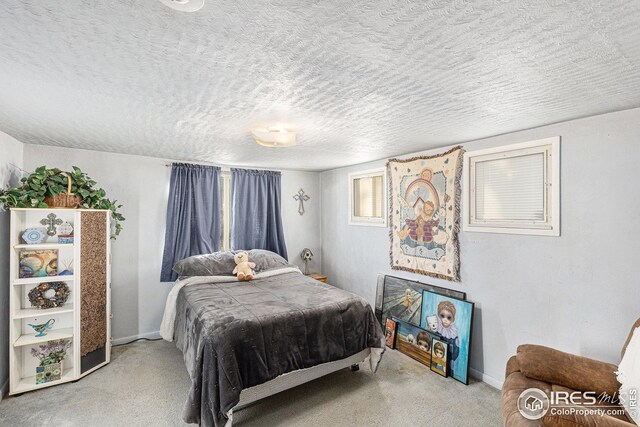 carpeted bedroom with a textured ceiling