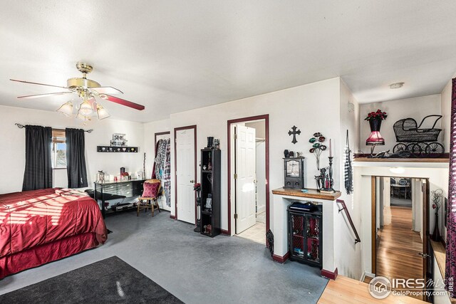 bedroom with ceiling fan and concrete floors