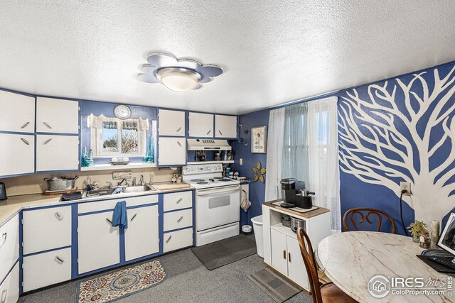 kitchen with a textured ceiling, white cabinetry, and electric stove