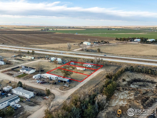 birds eye view of property with a rural view