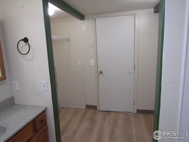 interior space with vanity and hardwood / wood-style flooring