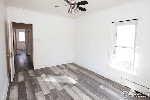 spare room with ceiling fan, ornamental molding, hardwood / wood-style floors, and a baseboard heating unit