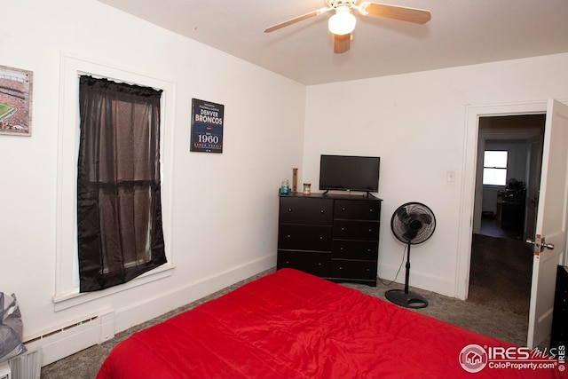 bedroom with ceiling fan, a baseboard radiator, and carpet flooring