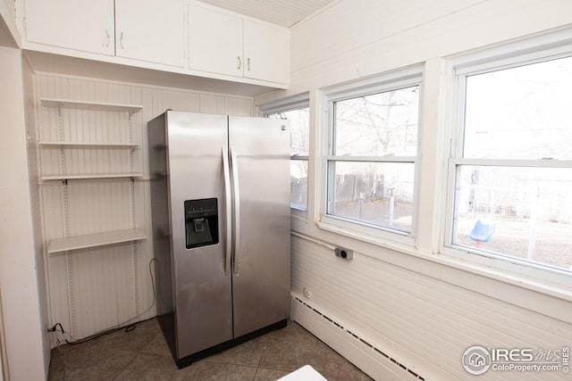 kitchen featuring baseboard heating, dark tile patterned floors, white cabinets, and stainless steel refrigerator with ice dispenser