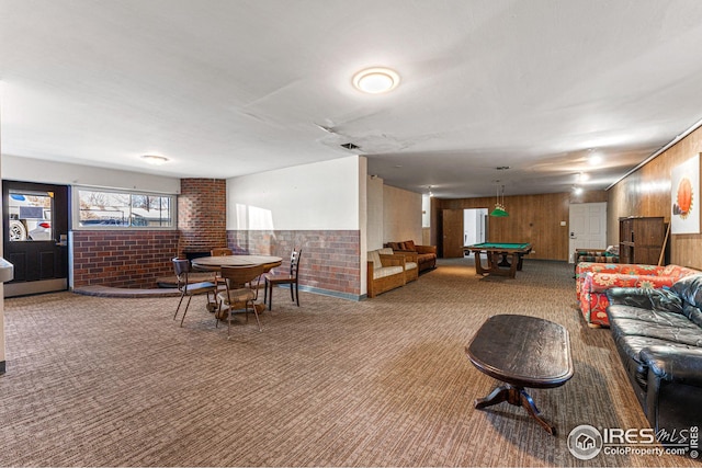 interior space featuring carpet, brick wall, wooden walls, and pool table