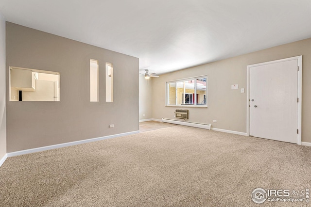 unfurnished living room featuring ceiling fan, carpet, and a baseboard heating unit