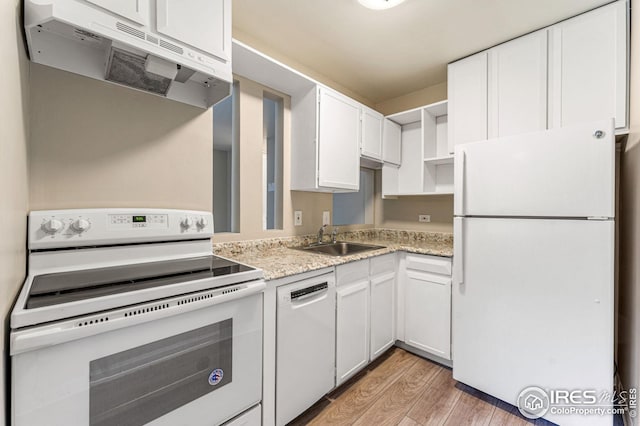 kitchen featuring white appliances, white cabinets, sink, light hardwood / wood-style flooring, and light stone countertops