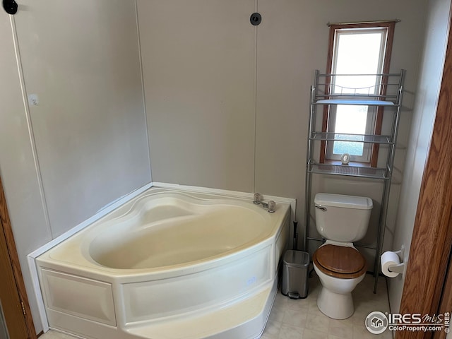 bathroom featuring a washtub and toilet