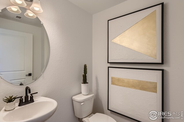 bathroom with toilet and sink