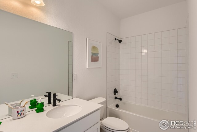 full bathroom with vanity, toilet, and tiled shower / bath