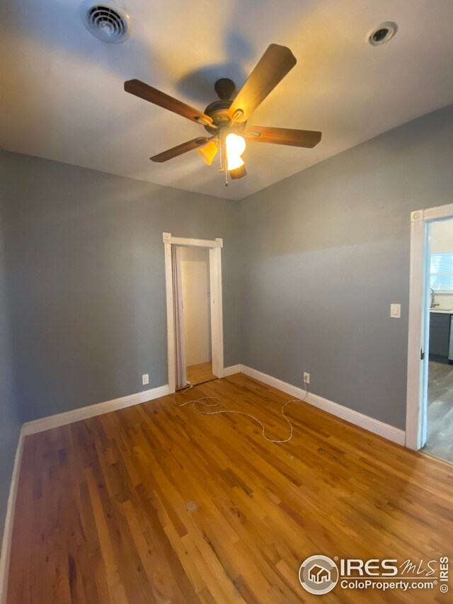 spare room featuring ceiling fan and wood-type flooring