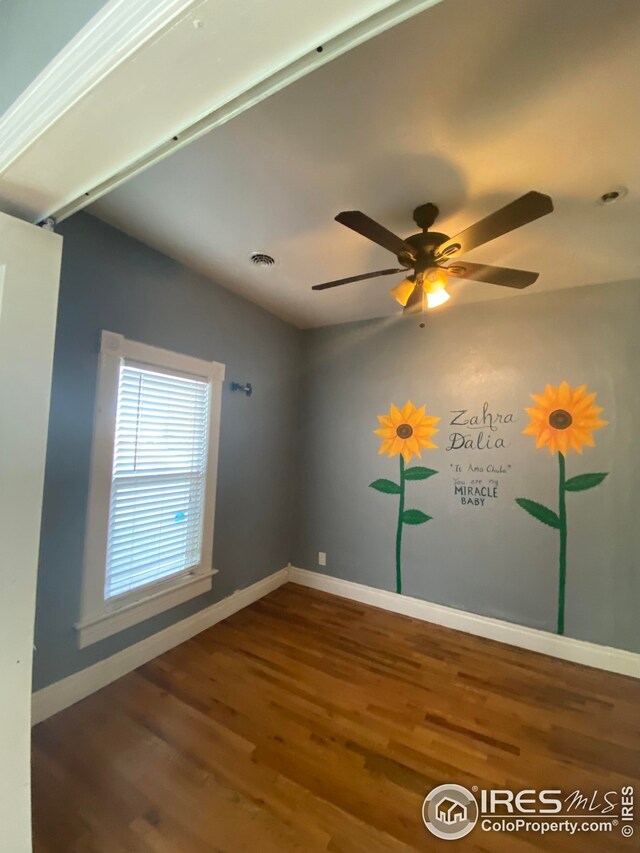 spare room featuring ceiling fan, wood-type flooring, and vaulted ceiling