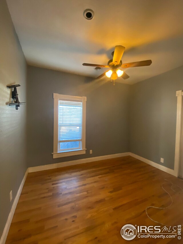 spare room with ceiling fan and hardwood / wood-style floors