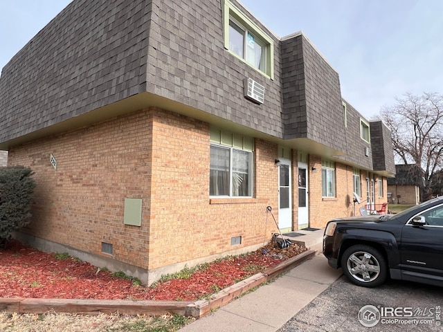 view of property exterior with a wall unit AC