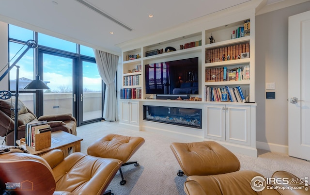 living room featuring built in shelves and light colored carpet