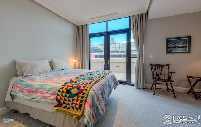 bedroom featuring access to outside, carpet, and a wall of windows