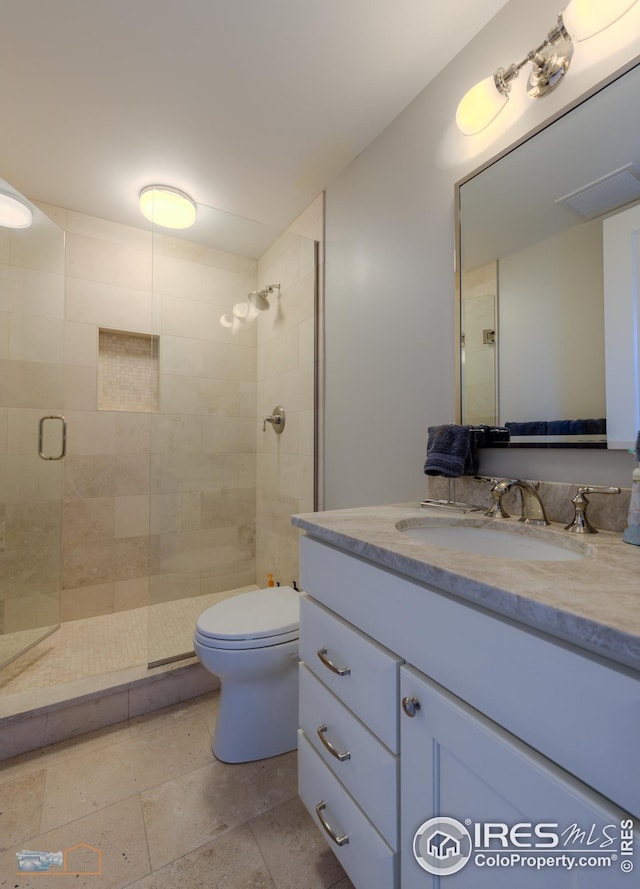 bathroom with vanity, toilet, and walk in shower