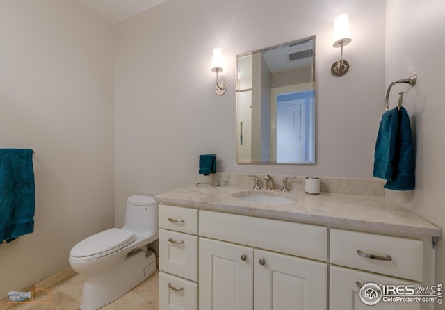 bathroom with vanity, tile patterned floors, and toilet