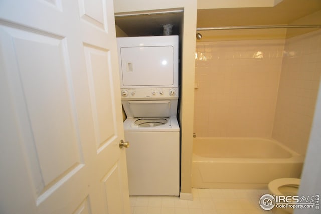 laundry room featuring stacked washer and dryer and laundry area