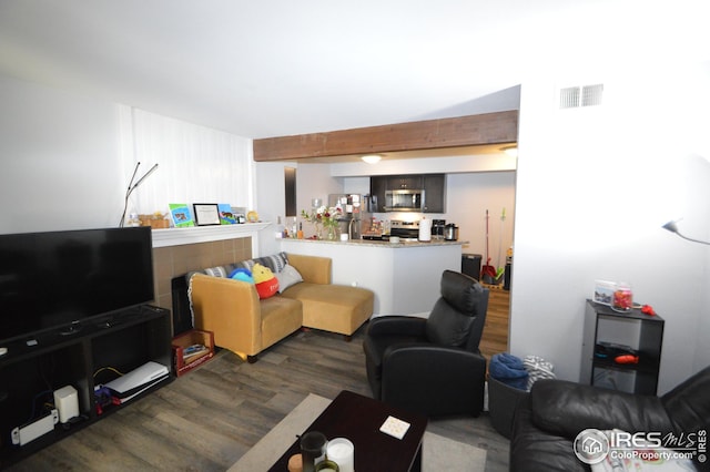 living room with wood finished floors and visible vents