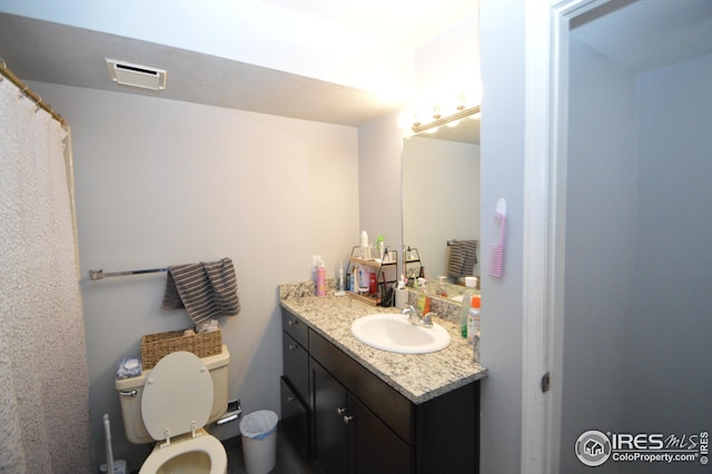 full bathroom featuring visible vents, vanity, and toilet