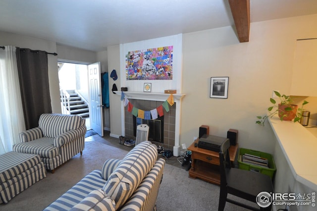 living area with carpet, a fireplace, and beamed ceiling