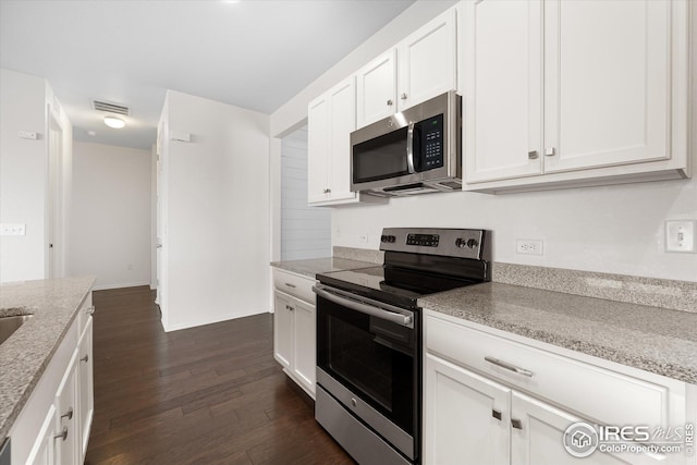 1604 Sorenson Dr, Windsor, CO 80550 - kitchen with light stone counters, stainless steel appliances, white cabinets, dark wood-style flooring, and visible vents