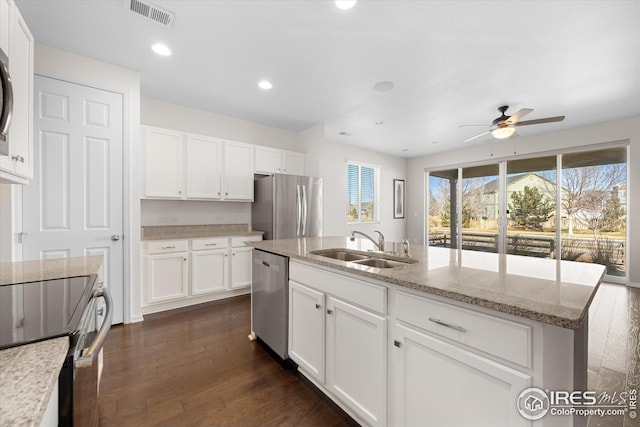 1604 Sorenson Dr, Windsor, CO 80550 - kitchen with stainless steel appliances, a sink, visible vents, white cabinetry, and a ceiling fan