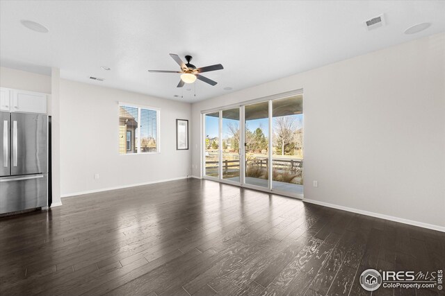 1604 Sorenson Dr, Windsor, CO 80550 - unfurnished living room with baseboards, dark wood-type flooring, and ceiling fan