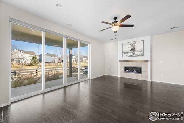 1604 Sorenson Dr, Windsor, CO 80550 - unfurnished living room with visible vents, a ceiling fan, wood finished floors, and a fireplace