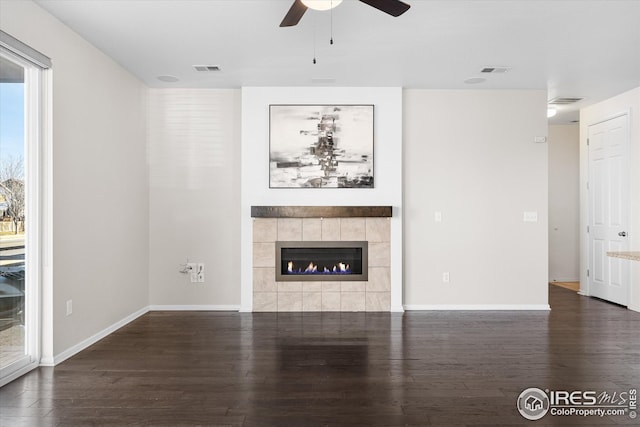 1604 Sorenson Dr, Windsor, CO 80550 - unfurnished living room with a ceiling fan, wood finished floors, a fireplace, baseboards, and visible vents