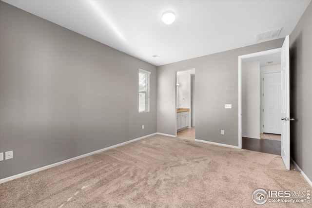 1604 Sorenson Dr, Windsor, CO 80550 - unfurnished bedroom with ensuite bath, carpet floors, visible vents, and baseboards