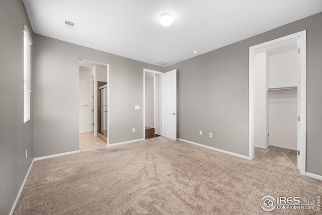 1604 Sorenson Dr, Windsor, CO 80550 - unfurnished bedroom with carpet flooring, baseboards, visible vents, and a walk in closet