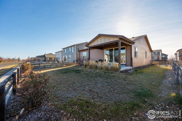 1604 Sorenson Dr, Windsor, CO 80550 - back of house featuring board and batten siding and a fenced backyard