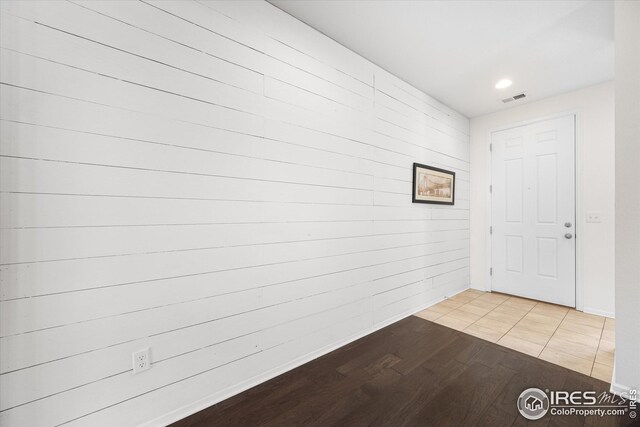 1604 Sorenson Dr, Windsor, CO 80550 - interior space with baseboards, visible vents, recessed lighting, light wood-style floors, and wooden walls
