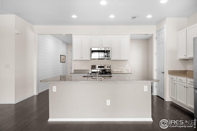 1604 Sorenson Dr, Windsor, CO 80550 - kitchen featuring white cabinets, dark wood-style flooring, stainless steel appliances, and visible vents