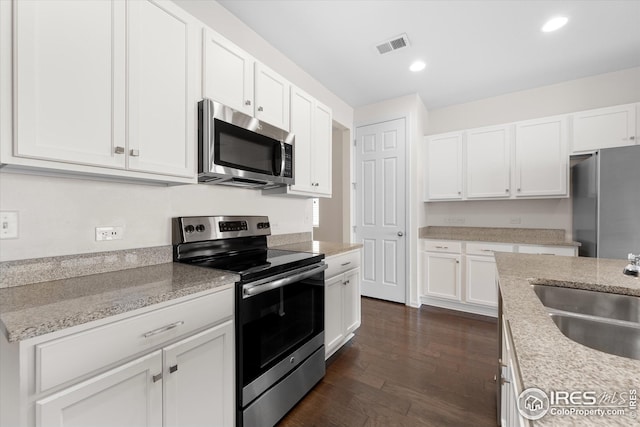 1604 Sorenson Dr, Windsor, CO 80550 - kitchen with visible vents, white cabinetry, stainless steel appliances, and a sink