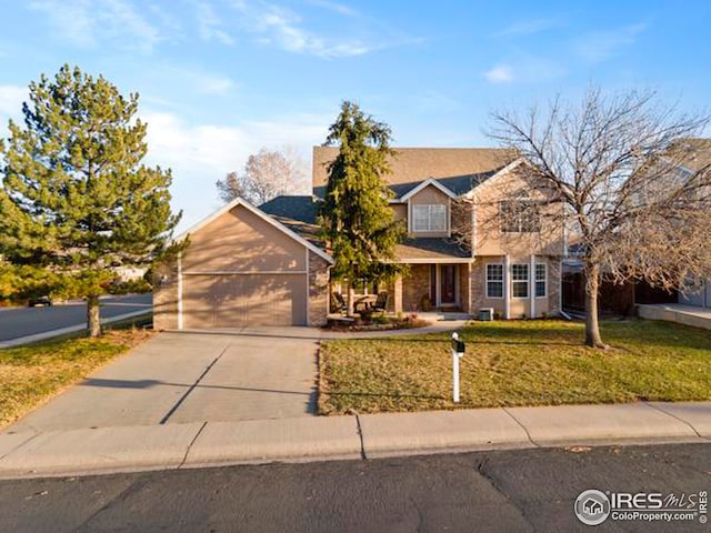 view of front of home with a garage and a front lawn