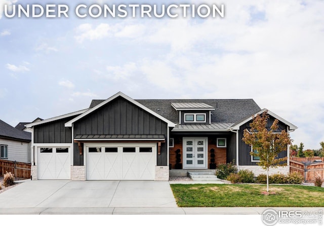 view of front of house with a garage and a front lawn