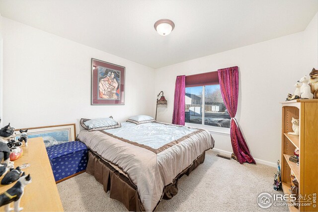 bedroom with light colored carpet