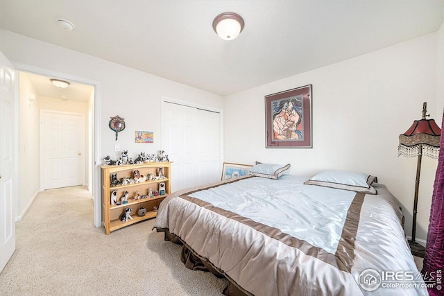 bedroom with light colored carpet and a closet