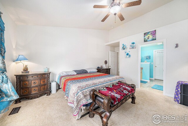 bedroom featuring light colored carpet, ensuite bath, and ceiling fan