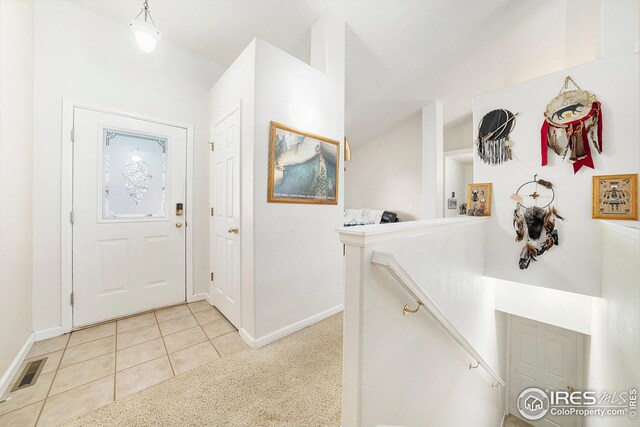 foyer entrance with light tile patterned flooring