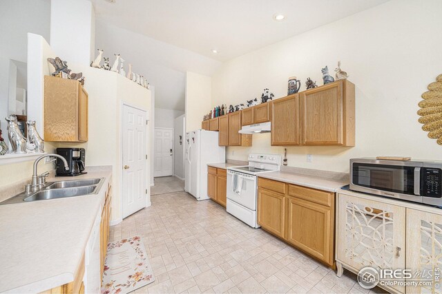 kitchen with white appliances, sink, and high vaulted ceiling