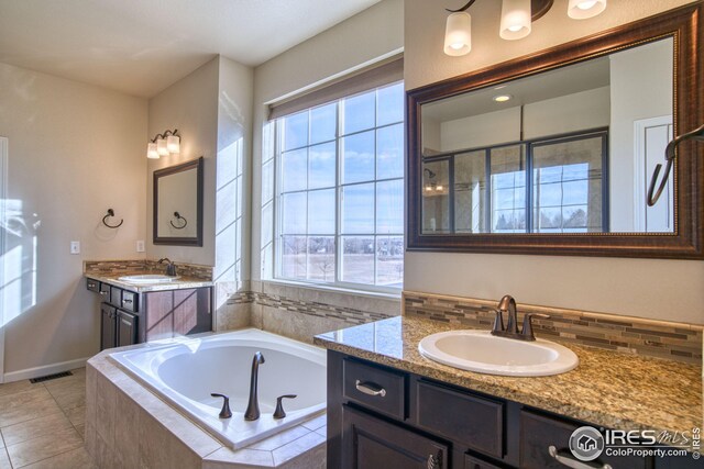 bathroom with tile patterned floors, decorative backsplash, vanity, and shower with separate bathtub