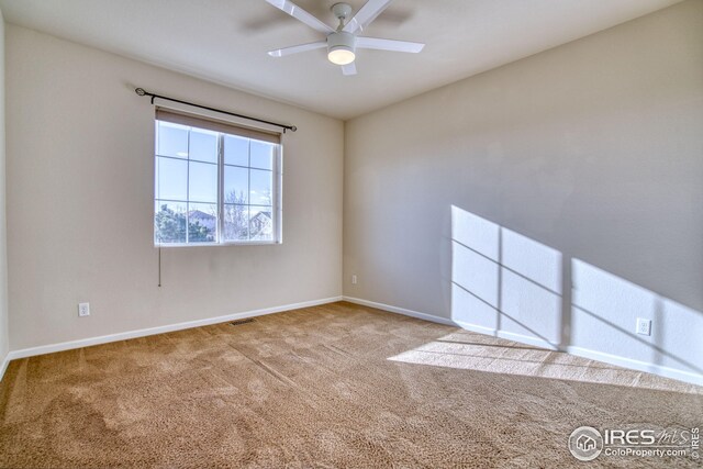 carpeted empty room with ceiling fan