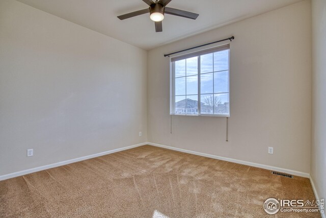 empty room with ceiling fan and carpet floors